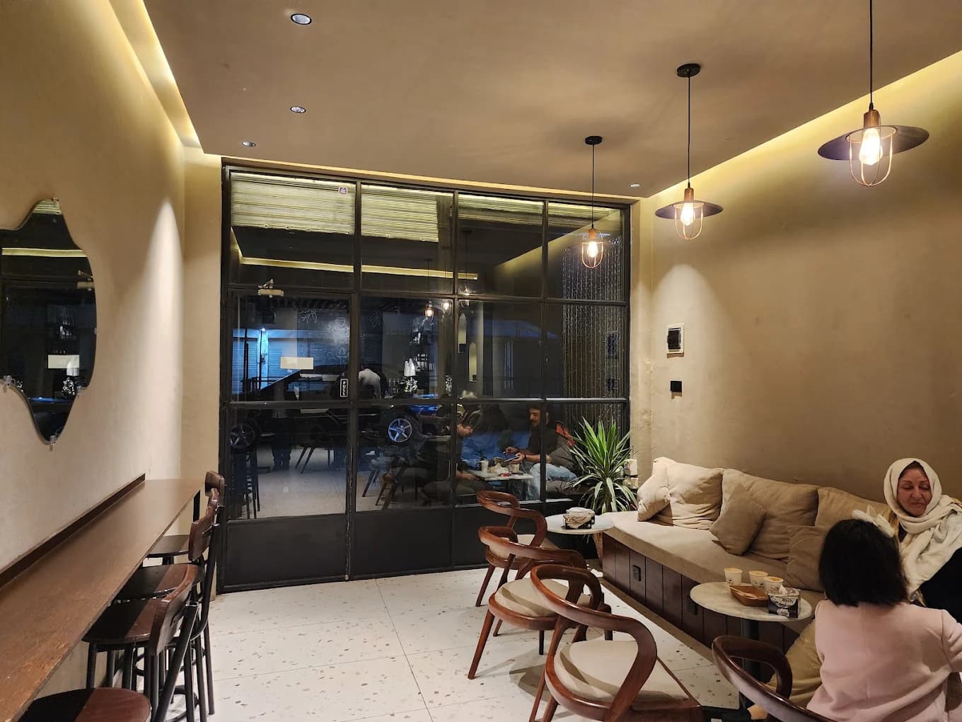 Cozy lounge seating with pendant lighting inside The Commons Coffee cafe